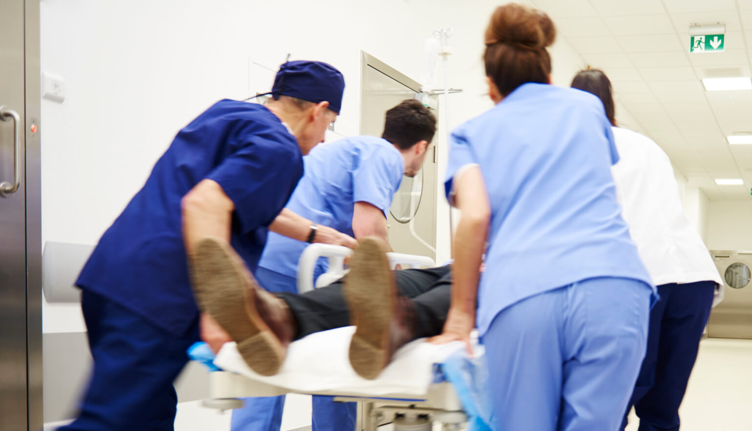 Doctors rushing patient in emergency room hospital